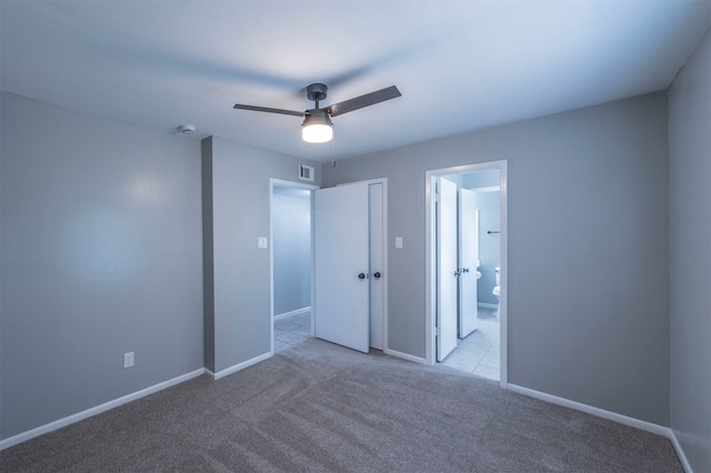 unfurnished bedroom featuring a closet, light carpet, and ceiling fan