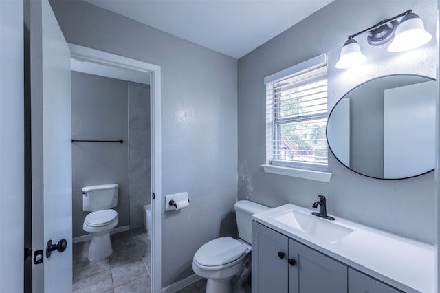 bathroom featuring vanity, tile patterned floors, and toilet