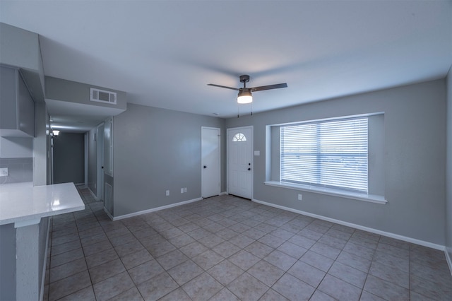 interior space with ceiling fan and light tile patterned floors