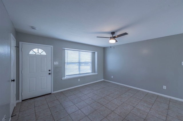 tiled foyer with ceiling fan