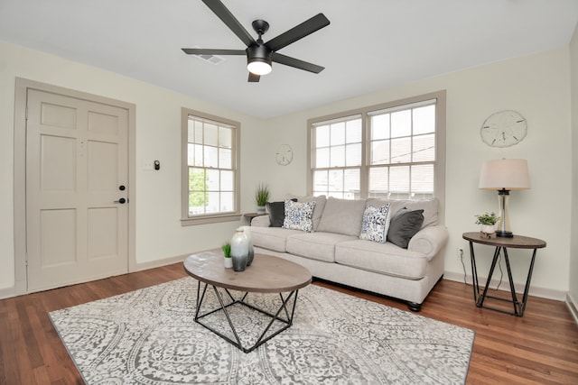 living room with ceiling fan, dark hardwood / wood-style floors, and plenty of natural light