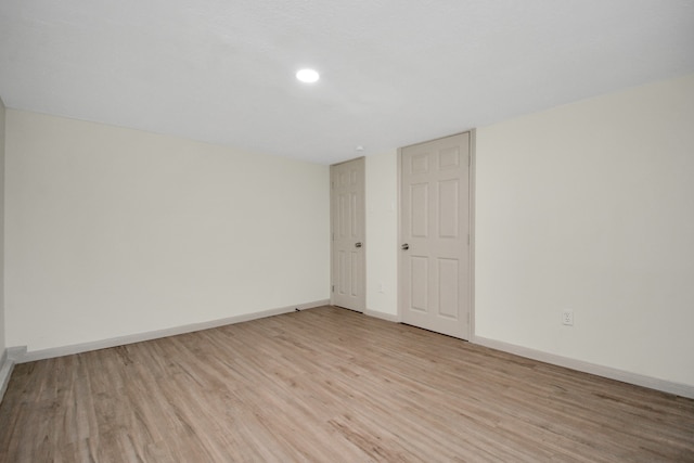 spare room featuring light hardwood / wood-style floors