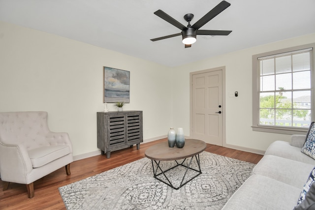 living room with wood-type flooring and ceiling fan