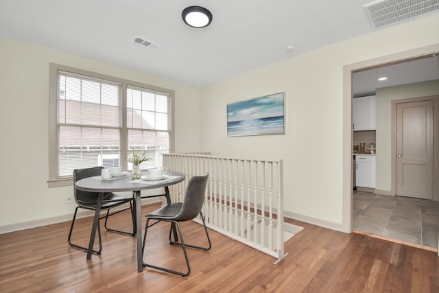 dining space with wood-type flooring