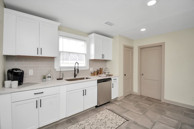 kitchen featuring white cabinetry, tasteful backsplash, stainless steel dishwasher, and sink