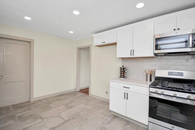 kitchen with appliances with stainless steel finishes, decorative backsplash, and white cabinets