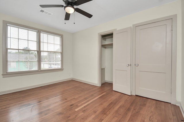 unfurnished bedroom featuring hardwood / wood-style floors and ceiling fan