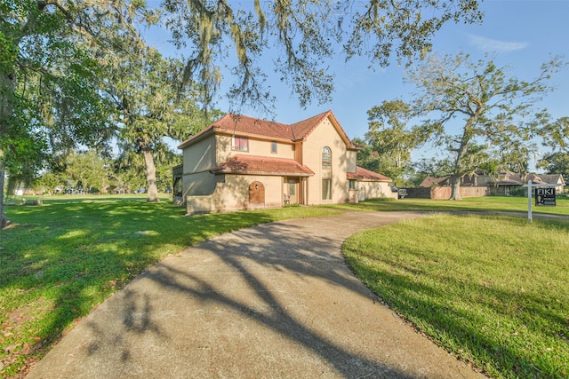 mediterranean / spanish-style home with a front lawn