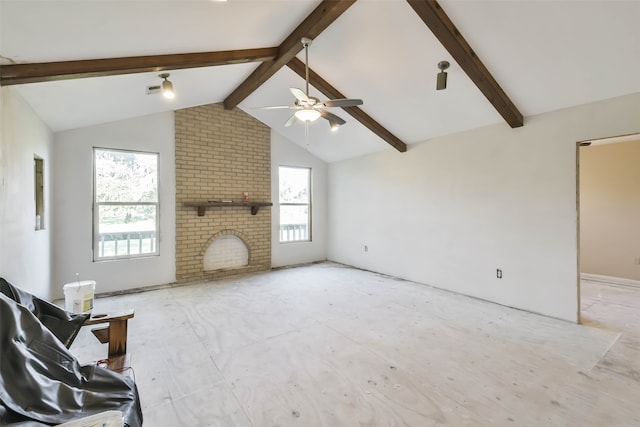 unfurnished living room with lofted ceiling with beams, ceiling fan, and a fireplace