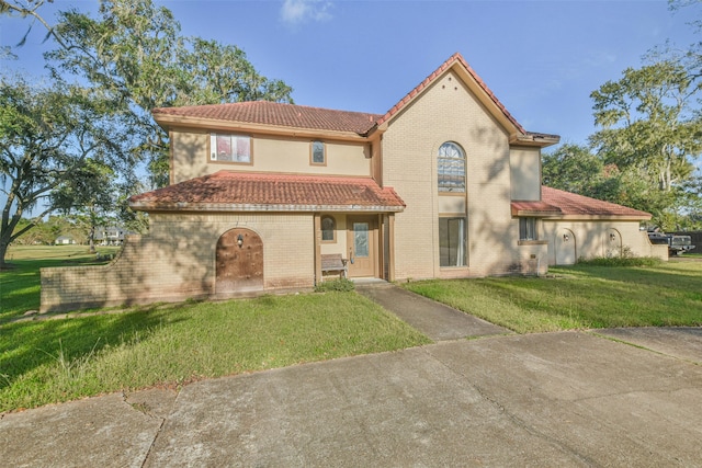 mediterranean / spanish-style home with a front yard