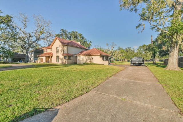 mediterranean / spanish-style home with a front yard