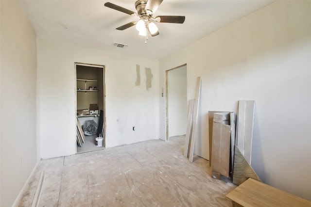 interior space with ceiling fan