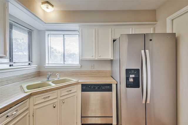 kitchen with white cabinetry, appliances with stainless steel finishes, and sink