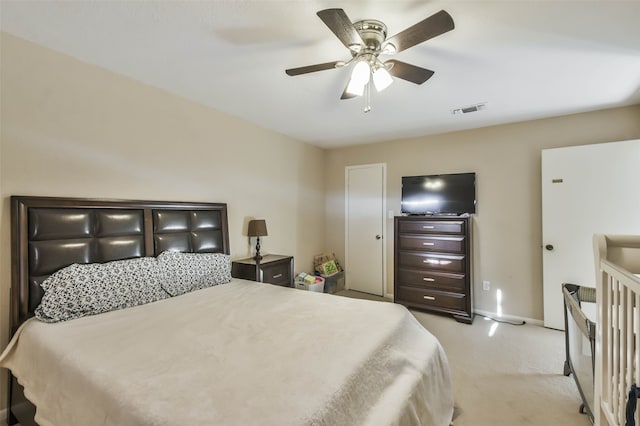 bedroom featuring light colored carpet and ceiling fan