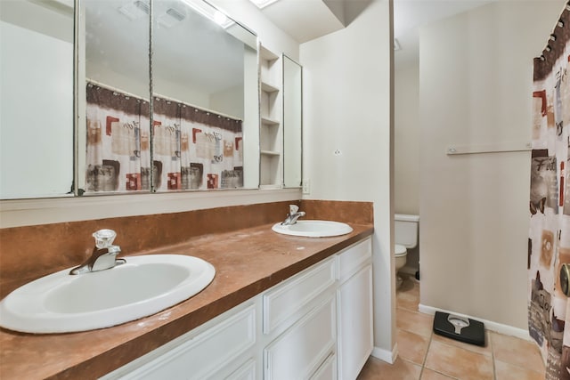 bathroom with walk in shower, tile patterned flooring, vanity, and toilet