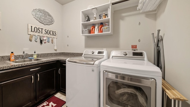 washroom featuring cabinets, independent washer and dryer, and sink