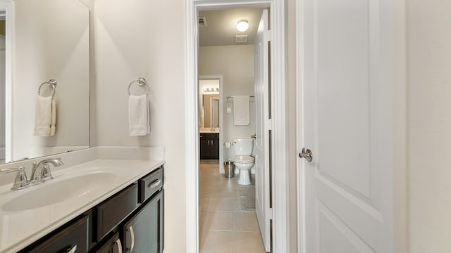 bathroom featuring tile patterned flooring, vanity, and toilet