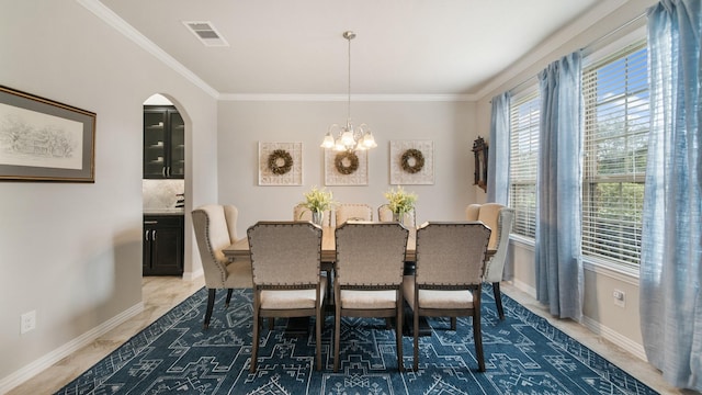 dining space featuring ornamental molding and a chandelier