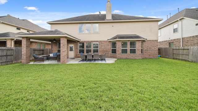 rear view of property with a patio area, ceiling fan, a yard, and an outdoor hangout area