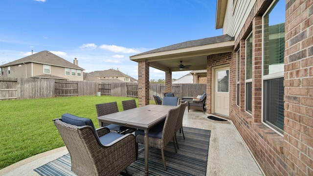 wooden terrace featuring a patio area, ceiling fan, and a yard