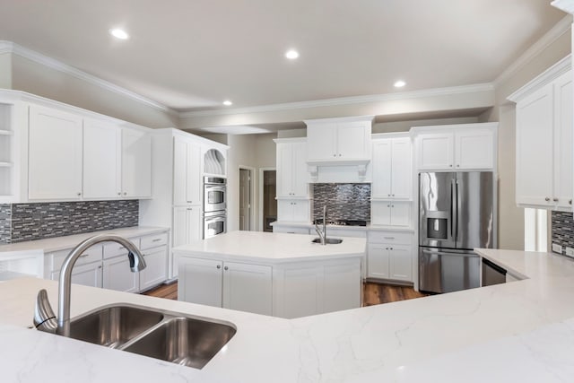 kitchen featuring white cabinets, stainless steel appliances, and sink