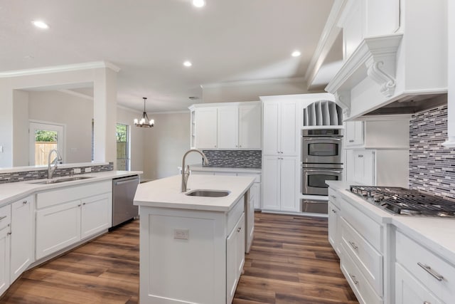 kitchen with decorative backsplash, sink, a kitchen island with sink, and appliances with stainless steel finishes