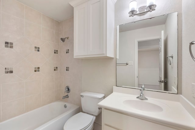 full bathroom with vanity, toilet, and tiled shower / bath combo