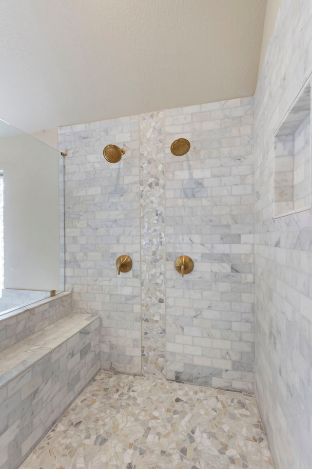 bathroom with tiled shower