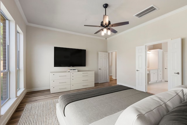 bedroom with ceiling fan, hardwood / wood-style floors, ensuite bathroom, and ornamental molding