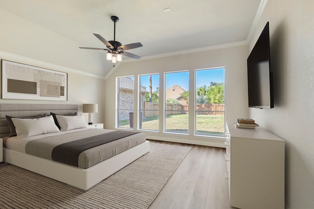 bedroom featuring ceiling fan, light hardwood / wood-style floors, ornamental molding, and vaulted ceiling