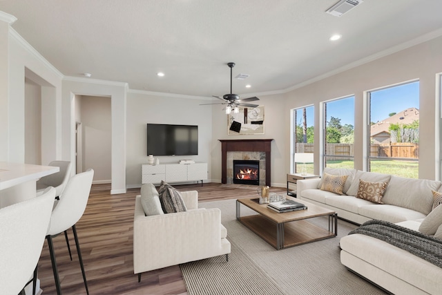 living room featuring ceiling fan, dark hardwood / wood-style floors, and ornamental molding