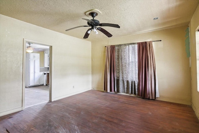 unfurnished room featuring ceiling fan, wood-type flooring, and a textured ceiling