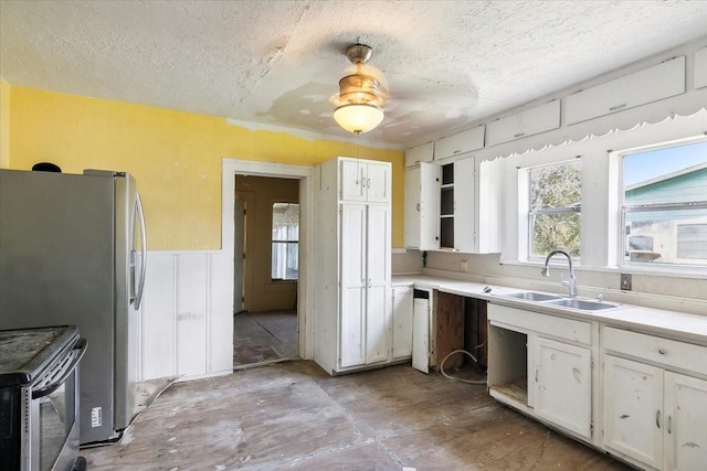 kitchen with white cabinetry, sink, ceiling fan, a textured ceiling, and appliances with stainless steel finishes