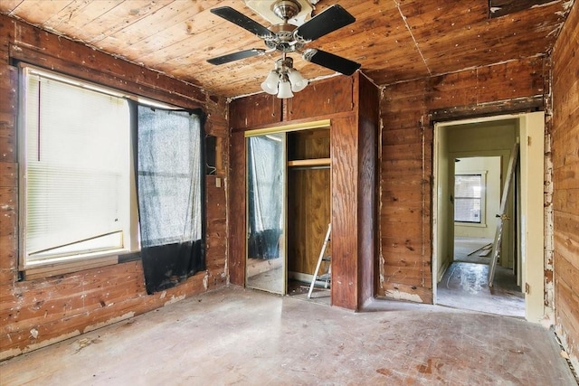 miscellaneous room featuring ceiling fan, plenty of natural light, wooden walls, and wood ceiling