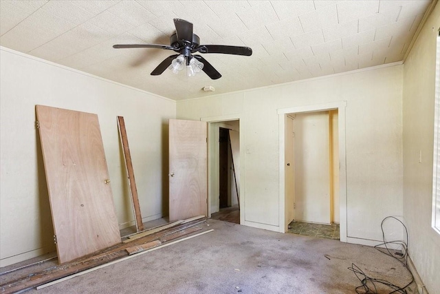 interior space with light colored carpet, ceiling fan, and ornamental molding