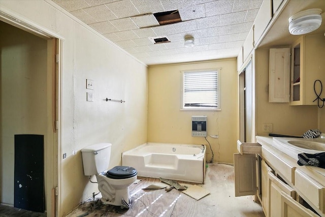 bathroom featuring a bath, heating unit, toilet, vanity, and ornamental molding