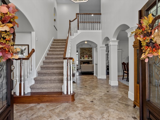 entryway with ornate columns and a towering ceiling