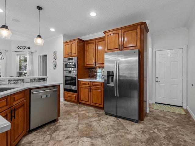 kitchen featuring ornamental molding, decorative light fixtures, appliances with stainless steel finishes, and tasteful backsplash