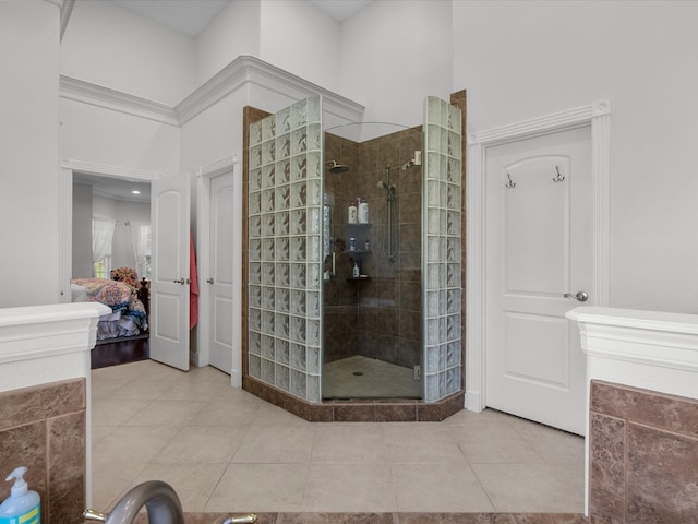 bathroom featuring tile patterned flooring and a tile shower