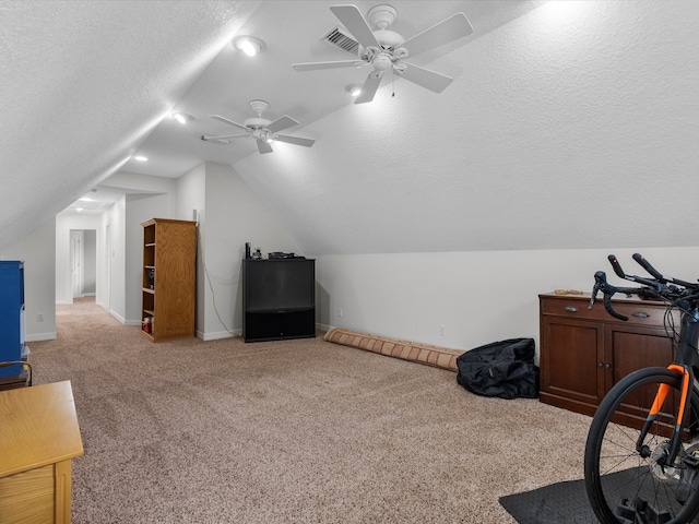 bonus room with ceiling fan, a textured ceiling, carpet flooring, and vaulted ceiling