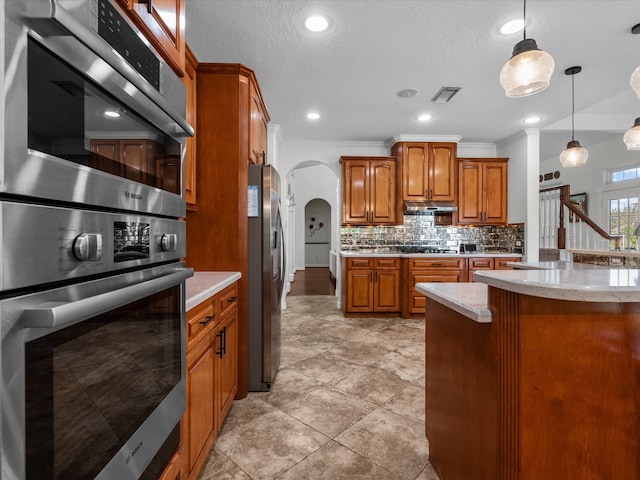 kitchen featuring tasteful backsplash, crown molding, stainless steel appliances, a textured ceiling, and pendant lighting