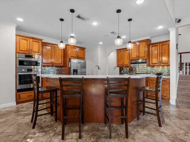 kitchen featuring a spacious island, stainless steel appliances, ornamental molding, and pendant lighting