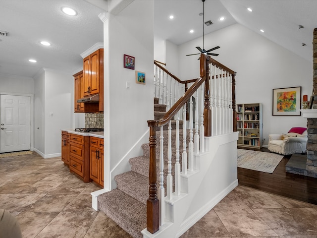 stairway featuring high vaulted ceiling, hardwood / wood-style flooring, ceiling fan, and crown molding