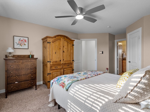 carpeted bedroom featuring connected bathroom, a textured ceiling, and ceiling fan