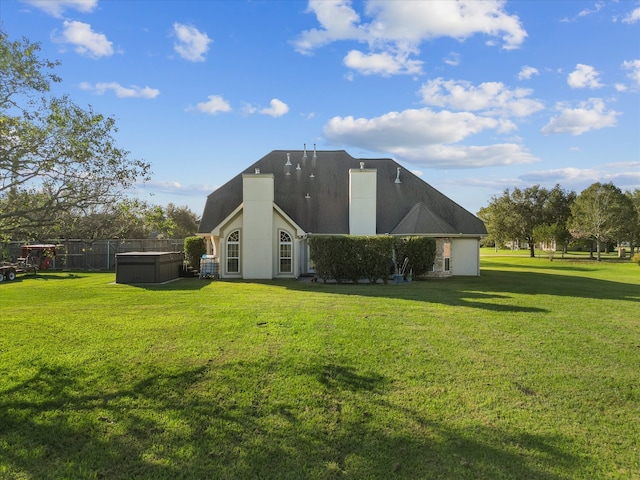 rear view of house featuring a yard