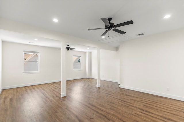 basement featuring ceiling fan, plenty of natural light, and wood-type flooring