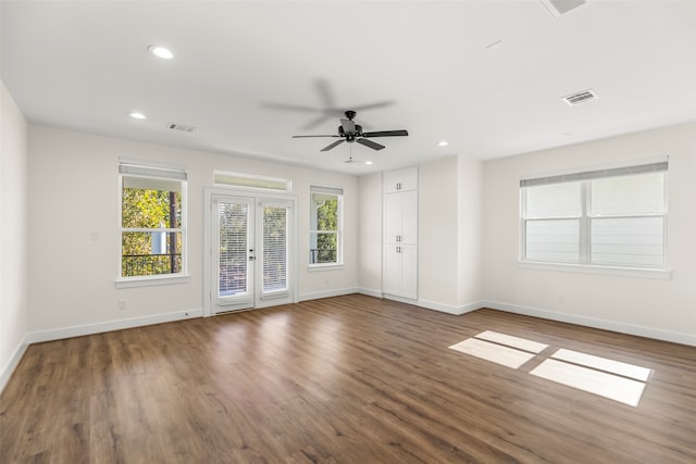 spare room with dark hardwood / wood-style floors, ceiling fan, and french doors