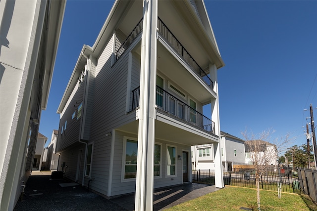 view of side of property with a balcony