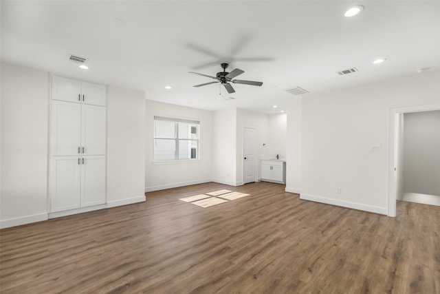 unfurnished living room featuring dark hardwood / wood-style floors and ceiling fan