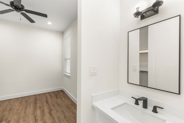 bathroom featuring vanity, ceiling fan, and wood-type flooring